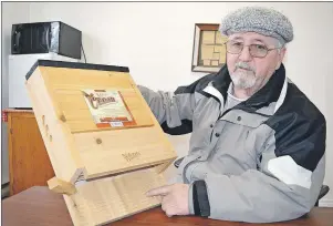  ?? SHARON MONTGOMERY-DUPE/CAPE BRETON POST ?? Stan Peach, treasurer of the Port Morien Wildlife Associatio­n, holds up a bat house that is capable of holding upwards of 300 bats. Peach said bats are declining across the province and as a result the associatio­n has applied for a grant to build and...