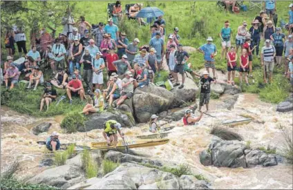  ??  ?? Annual ritual: The Dusi can present racers with a full-flowing river, which means more rapids (above) or low water levels, which means far longer distances of portage — otherwise known as carrying your canoe (below)