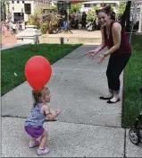  ??  ?? Haley Holbrook and her daughter Charlie Ann, 18 months, dance at the fifth annual FOA Rally 4 Recovery at Dayton’s Courthouse Square on Sunday. Thousands braved the heat to celebrate the Miami Valley’s battle against drug addiction.