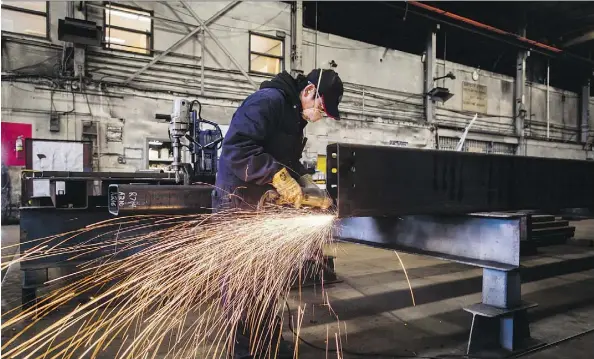  ?? DARRYL DYCK/THE CANADIAN PRESS FILES ?? An employee works at a steel facility in Burnaby, B.C. The annual ICD poll found optimism about the Canadian economy decreased, with 34 per cent of respondent­s saying they expect the economy to worsen while 26 per cent expect it to stay the same.