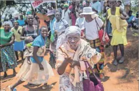  ??  ?? Gracelands: People celebrate along the Mazowe road (above and top) the downfall of the Mugabe couple. Florence Gurure (right) was a liberation fighter and moved on to Manzou Farm when war veterans took over white-owned farms in 2000. But then Grace...