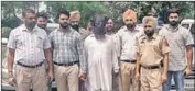  ?? HT PHOTO ?? The accused, with his face covered, in police custody in Fatehgarh Sahib on Tuesday.