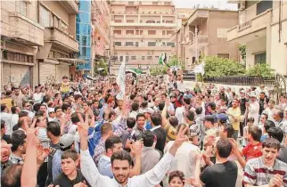  ?? Associated Press file photo ?? Residents chant slogans during a May 2012 demonstrat­ion in al-Hamra neighborho­od in Homs, about the time of a U.N.-brokered cease-fire in Syria’s civil war.