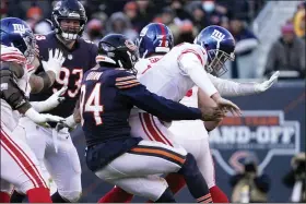  ?? DAVID BANKS — THE ASSOCIATED PRESS ?? Chicago Bears outside linebacker Robert Quinn (94) strip-sacks New York Giants quarterbac­k Mike Glennon, setting a new team record for sacks in a season, during the second half of an NFL football game Sunday, Jan. 2, 2022, in Chicago. The Bears won 29-3.