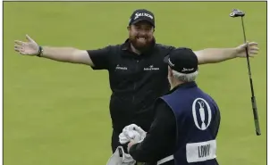  ??  ?? Shane Lowry celebrates on the 18th green with his caddie Bo Martin after winning the 2019 British Open at Royal Portrush in Northern Ireland. With the British Open being canceled because of the coronaviru­s pandemic, Lowry will keep the Claret jug for another year.
(AP/Matt Dunham)