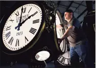  ?? Elise Amendola / Associated Press ?? Dan LaMoore works on a Seth Thomas Post Clock at Electric Time Company on Oct. 23 in Medfield, Mass.