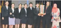  ??  ?? Clarence (second right) presents the Rijeng Challenge Trophy to the winning team, comprising teacher trainees majoring in mathematic­s.