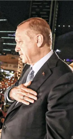  ??  ?? PRESIDENT RECEP TAYYIP ERDOGAN greeting supporters from a balcony at the headquarte­rs of the AK Party in Ankara on June 24. A handout photograph.