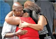  ?? ASSOCIATED PRESS FILE PHOTO ?? Leshea White and Kimberly Stallworth hug their uncle Roger Bracey, who was at Burnette Chapel Church of Christ when shots were fired last Sunday in Antioch, Tenn.