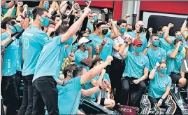  ?? AP ?? Mercedes driver Lewis Hamilton (C) celebrates with his team after winning the Imola GP.