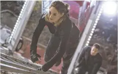  ?? JAAP BUITENDIJK, SUMMIT ENTERTAINM­ENT ?? Tris (Shailene Woodley) and Four (Theo James) meet at a dystopian warrior academy in a futuristic Chicago and fall in love.