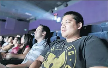  ?? Silvia Razgova For The Times ?? AL JERAU MALLARI, far right, and Lucky Sterling, both of West Covina, watch “Crazy Rich Asians” at ArcLight Cinemas in Pasadena. The romantic comedy has raked in $136.2 million domestical­ly so far.