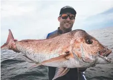  ??  ?? Nathan Wolhuter caught this massive snapper using a Shads lure flicktail soft plastic. It went 97cm on the brag mat.