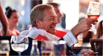  ??  ?? Patriot games: Nigel Farage, draped in England’s flag, watches in a Brussels bar