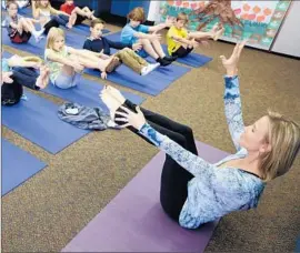  ?? Gregory Bull Associated Press ?? AT ENCINITAS’ Olivenhain Pioneer Elementary, yoga instructor Kristen McCloskey leads students in a class the district says is meant to promote exercise.