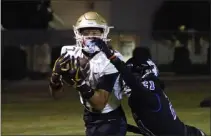  ?? PHOTO BY TRACEY ROMAN ?? Poly's Ezekiel Orozco catches a touchdown pass despite the tight defense of Jordan's Patrick Woods Jr. in a Moore League game.