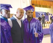  ?? CHRISTOPHE­R LEE/THE NEW YORK TIMES ?? Lt. Donzel Cleare, who leads the Junior Citizens Police Academy at Liberation Diploma Plus High School, center, with students during a June graduation ceremony at the school in Brooklyn’s Coney Island.