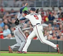  ?? John Bazemore / The Associated Press ?? Washington’s Trea Turner (7) is tagged out by Atlanta first baseman Freddie Freeman during the third inning of Thursday’s game at SunTrust Park.