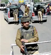  ?? — PTI ?? Policemen conduct a search operation in Jammu and Sunday after three youth attacked the personal security officer of a cleric and snatched his AK-47 rifle.