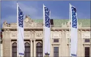  ?? ASSOCIATED PRESS FILE PHOTO ?? Flags wave in the wind in front of the entrance of the Permanent Council of the Organizati­on for Security and Cooperatio­n in Europe, OSCE, in Vienna, Austria, in 2022.