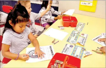  ?? RACHEL DICKERSON/MCDONALD COUNTY PRESS ?? Alimay Johnny colors with her kindergart­en class at Noel Primary School.