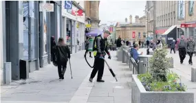  ??  ?? Keeping it clean Dealing with discarded gum in Paisley’s High Street