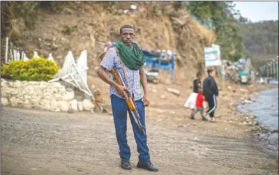  ??  ?? Amhara militia member Nega Wagaw poses on a street in Gondar, in the Amhara region of Ethiopia.