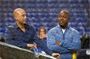  ?? AP Photo/Wilfredo Lee ?? In this 2019 file photo, Miami Marlins CEO Derek Jeter (left) and Michael Hill, President of Baseball Operations, watch batting practice before the start of a baseball game against the Cincinnati Reds, in Miami.