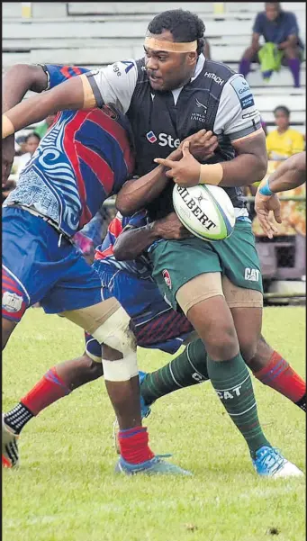  ?? Picture: ELIKI NUKUTABU ?? Vakatwa Uenavanua (with the ball) of Eastern Saints Gold is tackled by the Mokani defence during the Nausori 10s tournament at Ratu Cakobau Park in Nausori yesterday.