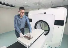  ?? ?? SCIENCE MEETS ART: Top, Dr Alex Surtees of Bradford University’s forensic science department with The Sandpit, one of three oil paintings being tested for scientific evidence that they may be by English artist John Constable; above left and right, Dr Surtees with the scanner test. .