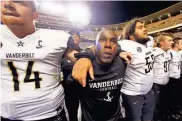  ?? / AP-Wade Payne, File ?? Vanderbilt head coach Derek Mason celebrates with his team after an NCAA college football game, in Knoxville, Tenn., on Nov. 25. Minorities make up only 19 percent of Division I head football coaches and less across the Power Five conference­s: the ACC,...