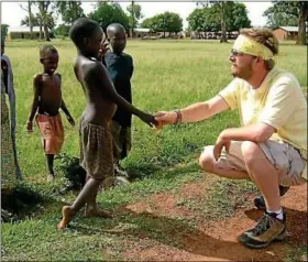  ?? Submitted photo ?? Sellersvil­le native Michael Kirkpatric­k greets some children during one of his trips to Uganda.