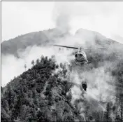  ?? ASSOCIATED PRESS ?? A HELICOPTER GATHERS water from the Merced River to fight the Ferguson Fire along steep terrain behind the Redbud Lodge near El Portal along Highway 140 in Mariposa County, Calif., on Saturday.