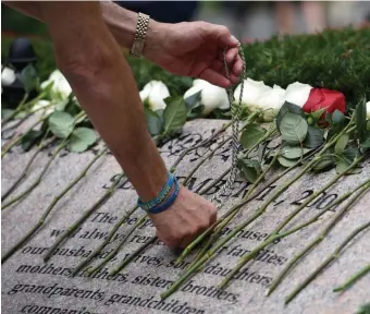  ?? FAITH nInIvAggI / bOSTOn HerALd ?? Lane Forman touched his Star of David on the 9/11 memorial wall in the Contemplat­ive Garden in 2018.