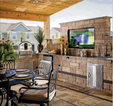  ?? CONTRIBUTE­D BY BELGARD ?? igh-tech outdoor kitchen and TV transform a basic patio.