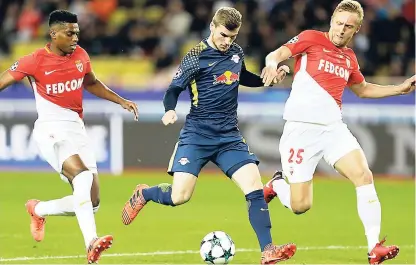  ??  ?? Leipzig’s Timo Werner (centre) dribbles Monaco’s Kamil Glik (right) before scoring during their Champions League Group G at the Louis II stadium in Monaco yesterday.