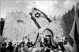  ?? LIOR MIZRAHI/GETTY ?? Israelis celebrate Sunday during a march outside Damascus Gate in Jerusalem. Israel marked Jerusalem Day, the 51st anniversar­y of what it calls the city’s unificatio­n.