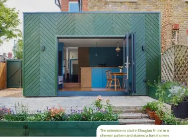  ??  ?? The extension is clad in Douglas fir laid in a chevron pattern and stained a forest green