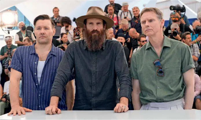  ?? ?? Joel Edgerton, director Thomas M. Wright, and Sean Harris pose for photograph­ers at the photo call for the film ‘The Stranger’ at the 75th Cannes Film Festival