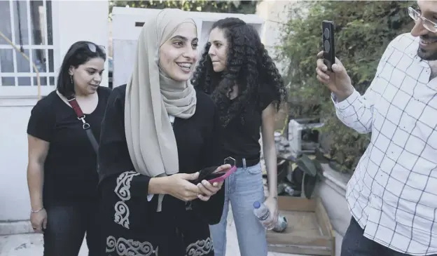  ??  ?? 0 Palestinia­n activist Muna el-kurd, 23, is welcomed home to Sheikh Jarrah in Israeli-annexed east Jerusalem after being released from an Israeli police station