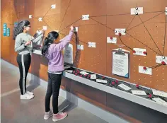  ?? ?? Play fighting: two young visitors use one of the exhibition’s interactiv­e displays