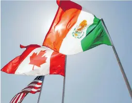  ?? AP ?? National flags of the United States, Canada and Mexico fly in New Orleans.