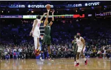  ?? MATT SLOCUM — THE ASSOCIATED PRESS ?? Boston’s Jayson Tatum goes up for the go-ahead shot against flailing Sixers defender De’Anthony Melton, left, while James Harden takes it all in from too far away last Saturday at Wells Fargo Center.