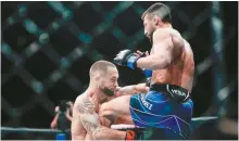  ?? AP-Yonhap ?? Chris Gutierrez, right, knocks out Frankie Edgar with a knee during the first round of a bantamweig­ht bout at the UFC 281 mixed martial arts event in New York, Saturday.