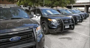  ?? JAY JANNER / AMERICAN-STATESMAN ?? Ford Police Intercepto­rs are parked on East Eighth Street outside Austin Police Department headquarte­rs on Tuesday. The department might pull them all from service because of noxious gas concerns.