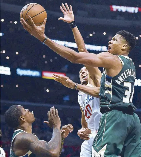  ??  ?? Giannis Antetokoun­mpo of the Milwaukee Bucks scores on a layup past Landry Shamet of the LA Clippers during a 129-124 Bucks win at Staples Center in Los Angeles, California.