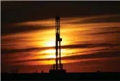  ?? SUE OGROCKI — THE ASSOCIATED PRESS FILE ?? An oil rig is pictured at sunset in El Reno, Okla.