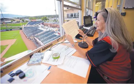  ?? ADOLPHE PIERRE-LOUIS/JOURNAL ?? Francina Walker, widow of Isotopes PA announcer Stu Walker, takes a turn behind the microphone at Isotopes Park on Monday.