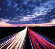  ?? MICHAEL PROBST — THE ASSOCIATED PRESS ?? Long exposure picture shows driving cars on the highway just before sunrise near Frankfurt , central Germany, Friday.