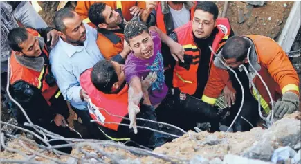  ?? Photo: REUTERS ?? Air strike survivor: Members of the Palestinia­n Civil Defence help a survivor pulled from under the rubble of his destroyed house after an Israeli air strike in Gaza City yesterday.